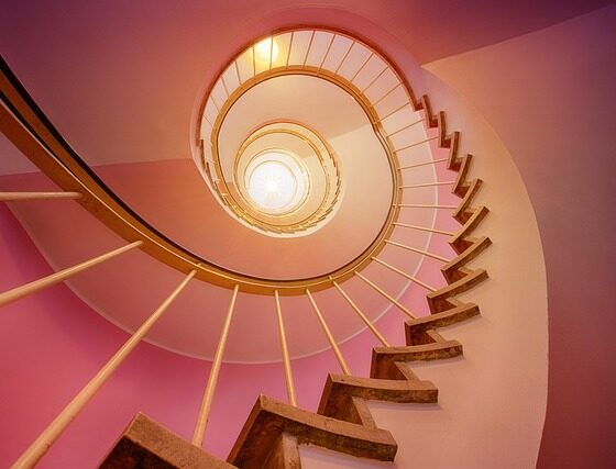 Orange-rosa Wendeltreppe die hoch hinauf zu einem hellen Licht führt und eine hypnotische, Trance induzierende Wirkung hat